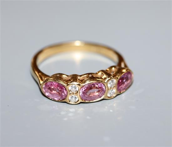 An 18ct gold, pink sapphire and diamond half-hoop ring, size M.